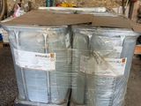 two large drums sitting on a pallet in a garage