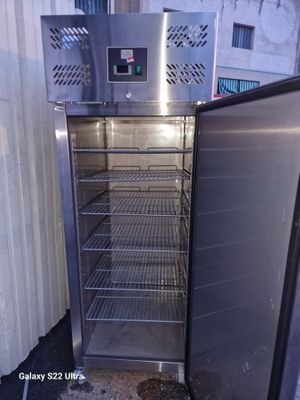 an open refrigerator that is sitting in the corner of a building