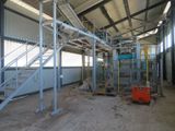 a large room with a staircase and a machine in it
