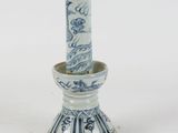 a blue and white vase sitting on a white surface