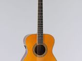an orange acoustic guitar sitting on top of a white surface