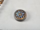 a wooden bead with a clock on it on a table