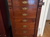 une commode ancienne en bois, dotée de poignées et de boutons en laiton