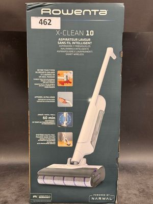 the box of a vacuum cleaner is sitting on the floor