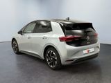 the rear end of a white volkswagen e - golf parked in a room