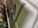 an old suitcase sitting on the side of the road