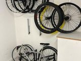many bikes that are hanging on the wall