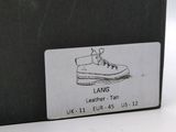 a black box with a label on it that says lang leather tan