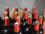 many bottles of red wine in a wooden box