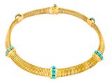 a gold necklace with turquoise stones on a white background