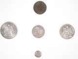 five different types of coins on a white surface