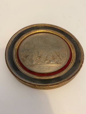 an image of a silver and gold coin on a white surface