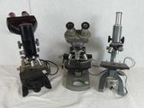 three microscopes that are sitting on a table