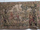 an image of a tapestry hanging on a wall with a picture of a man riding a horse