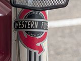 a close up of a red motorcycle with a checkered rear view mirror