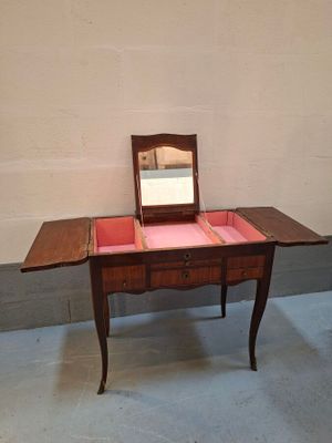 a small table with a mirror on top of it