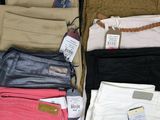many pairs of pants that are on display in a store