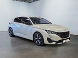the white car is parked in a large room with a white wall