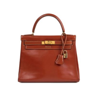 a brown leather handbag on a white background