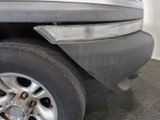 a close up of a car ' s front bumper and tire