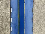 a blue window on the side of a concrete wall
