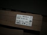 a label on a piece of wood that is on the floor