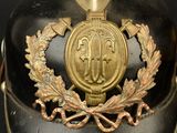 a black helmet with a gold emblem on it