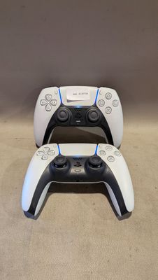 deux manettes de jeux vidéo posées l'une sur l'autre sur un tapis