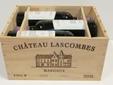 bottles of wine in a wooden box on a white surface