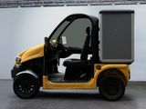 a yellow golf cart with a cooler on the back of it