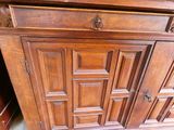 a wooden cabinet with a door and a drawer underneath it