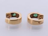 a pair of gold hoop earrings with turquoise stones