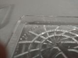a close up of a glass plate with a clock on it