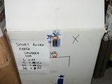 a person holding a box that has a sign on it