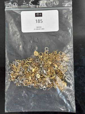 a bag of gold colored metal rings on a black table