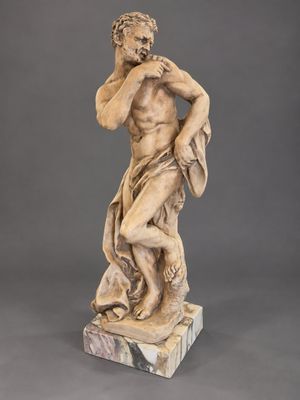 une image représentant la statue d'un homme tenant un chien dans ses bras