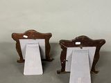 two wooden chairs that are sitting next to each other