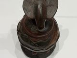 a statue of an elephant sitting on top of a bowl