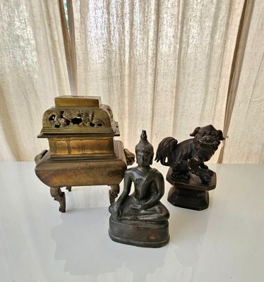 three statues sitting on a table next to a piano