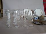many wine glasses and plates on the table