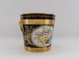 a black and gold vase with flowers on it