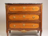 an antique chest of drawers with marble top and brass handles
