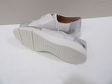 they are two pairs of white shoes on a white surface