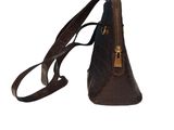 brown leather handbag with zippers and a strap on a white background