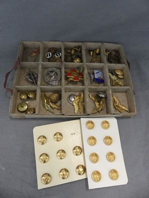 a box with a lot of gold and silver buttons