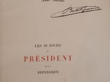 an old book with a handwritten signature on the cover
