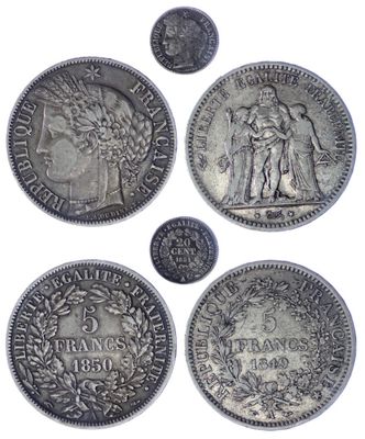 a group of five silver coins sitting on top of each other