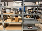 many shelves that have pots and pans on them