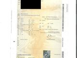 une photo d'un document sur laquelle figure la photo d'un homme