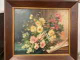 a painting of flowers in a vase on a easel